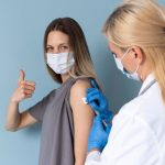 female-patient-with-medical-mask-getting-vaccine_23-2149014348